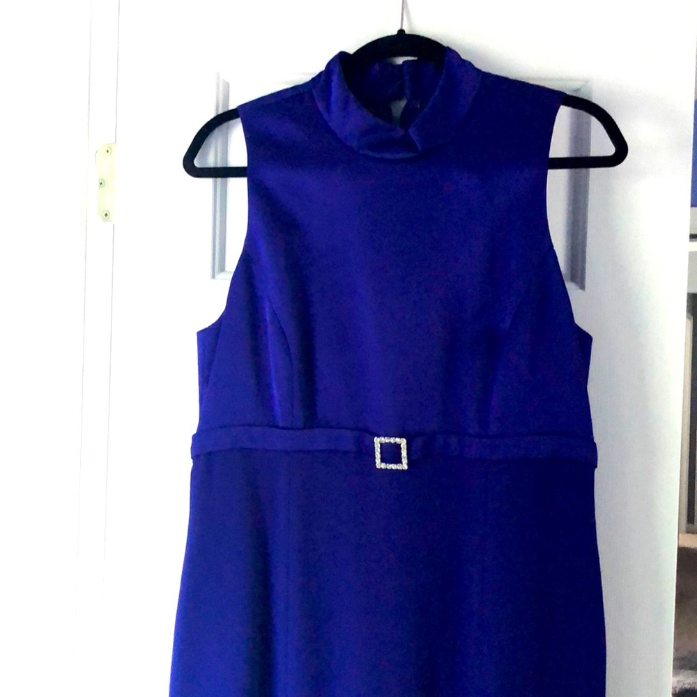 Sapphire blue long sleeveless formal gown with side slit. Faux rhinestone belt.